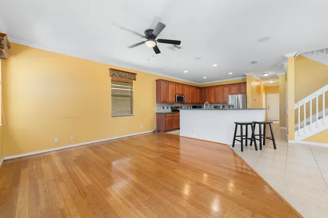 a kitchen with stainless steel appliances wooden cabinets a stove a sink and a microwave