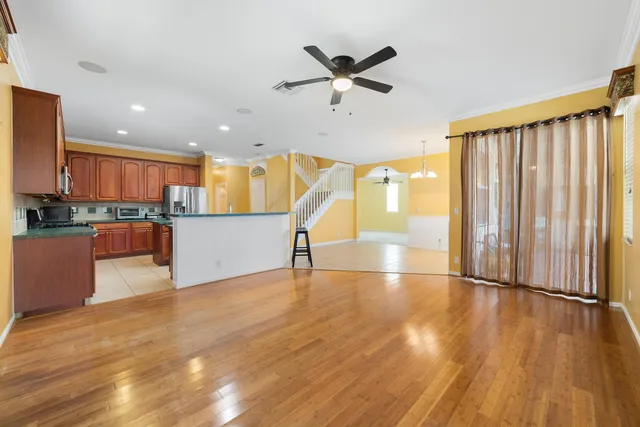 a kitchen with stainless steel appliances granite countertop a refrigerator sink and cabinets