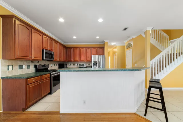 a kitchen with stainless steel appliances granite countertop a stove top oven sink and cabinets