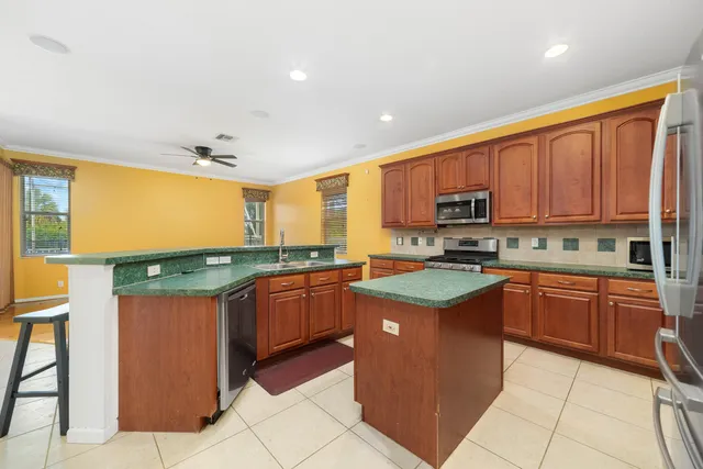 an empty room with closet and a ceiling fan