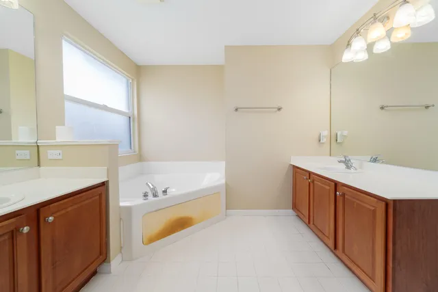 an empty room with wooden floor and ceiling fan