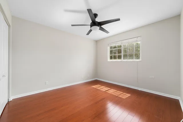 a view of an empty room with wooden floor