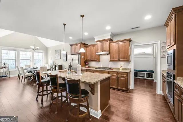 a large kitchen with a table and chairs