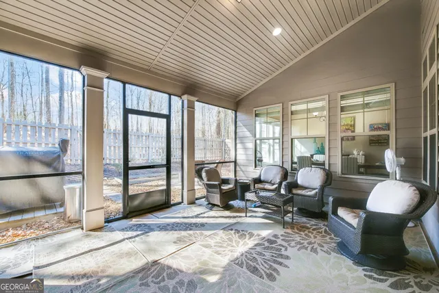 a living room with furniture and a floor to ceiling window