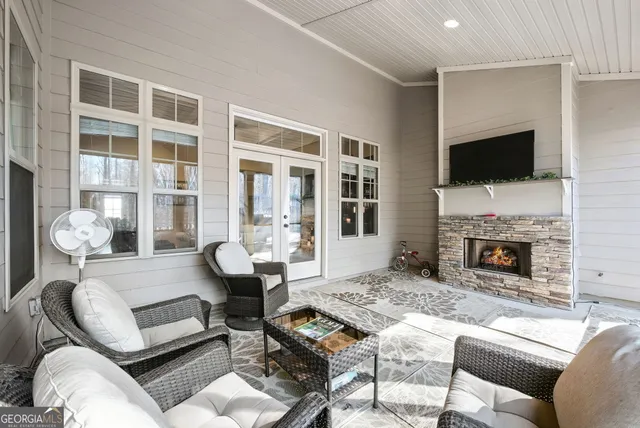 a living room with furniture fireplace and flat screen tv