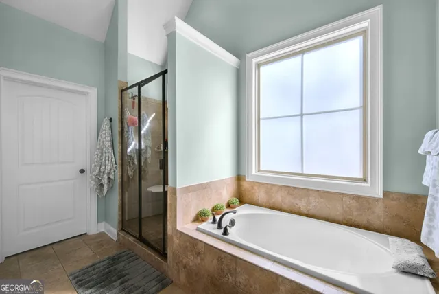 a bathroom with a tub and a shower