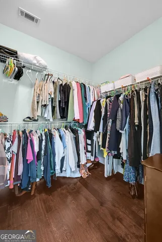 a view of walk in closet with clothes