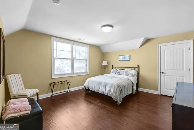 a bed room with a bed and a chair