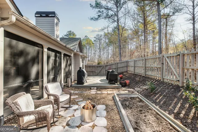 a view of a backyard with sitting area