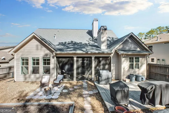 a front view of a house with patio furniture and garden