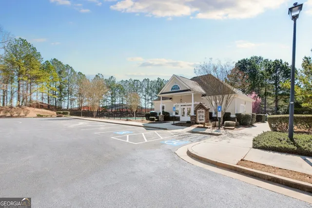 a view of a white house with a swimming pool and lawn chairs