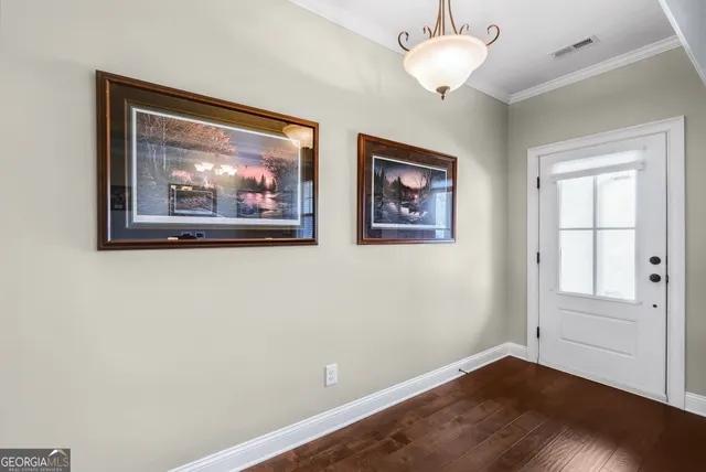 a view of room with window and wooden floor