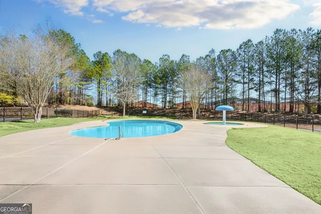 a view of a swimming pool with a yard