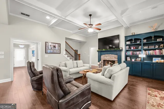 a living room with furniture a fireplace and a flat screen tv