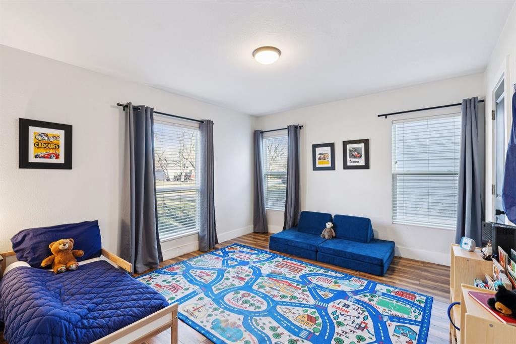 1237 Fuller Drive Dallas, TX 75218 - Photo 15 of 24 Large secondary bedroom with laminate floors