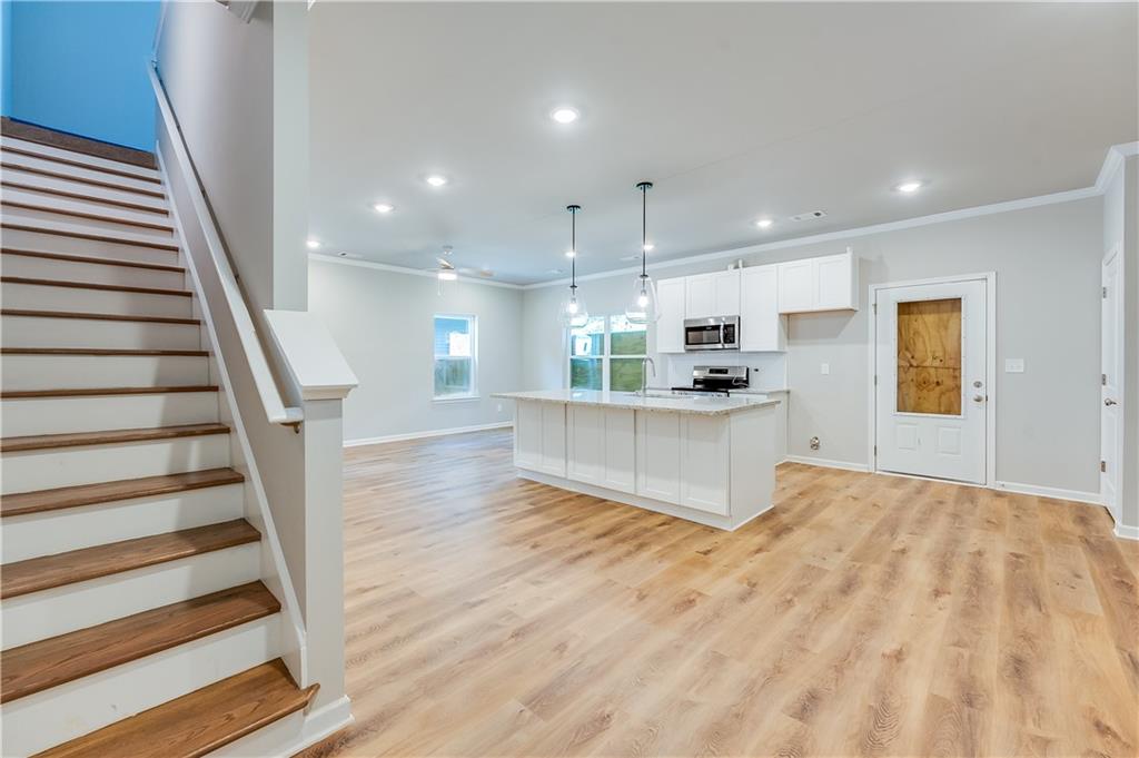 a view of kitchen with sink and wooden floor