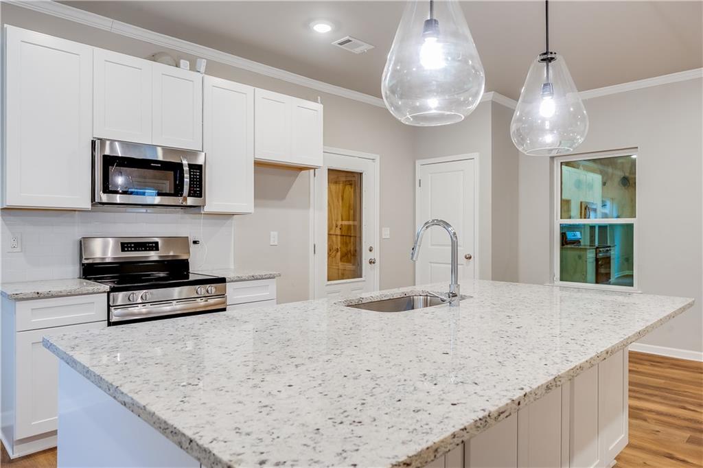 960 Lawton Street Southwest Atlanta, GA 30310 - Photo 5 of 16 a kitchen with stainless steel appliances granite countertop a sink and a microwave