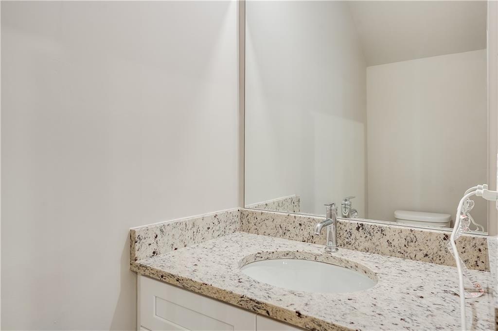 960 Lawton Street Southwest Atlanta, GA 30310 - Photo 6 of 16 a bathroom with a granite countertop sink and a mirror