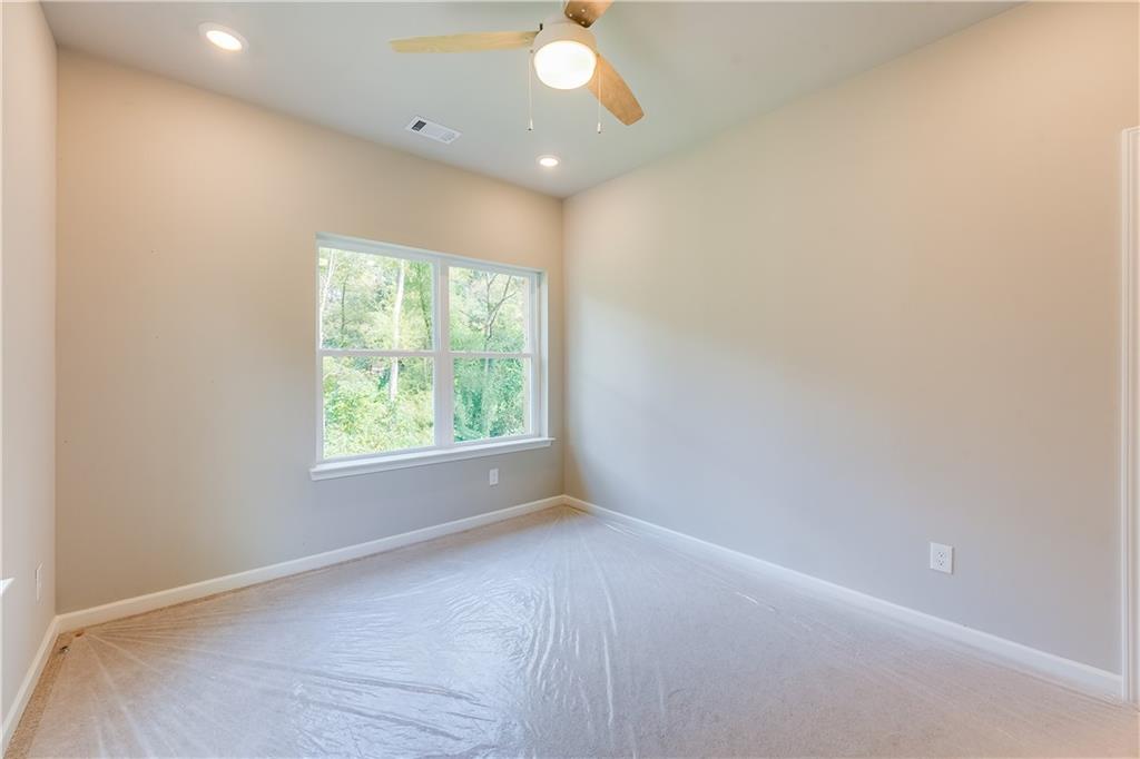 960 Lawton Street Southwest Atlanta, GA 30310 - Photo 9 of 16 an empty room with a window and a fan