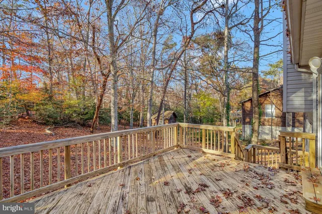 an empty room with windows and ceiling fan
