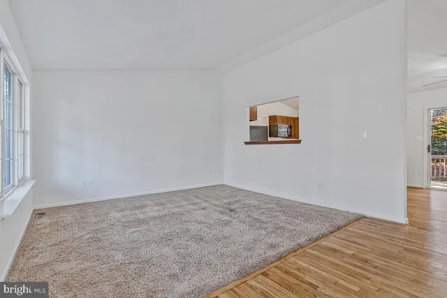 a view of empty room with a ceiling fan