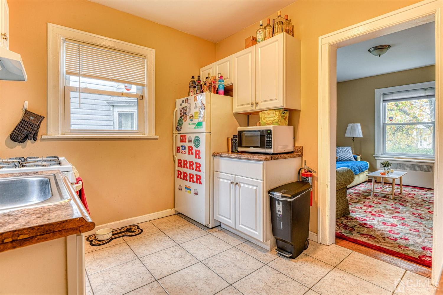 36 Baldwin Street New Brunswick, NJ 08901 - Photo 14 of 22 a view of a kitchen with fridge and workspace