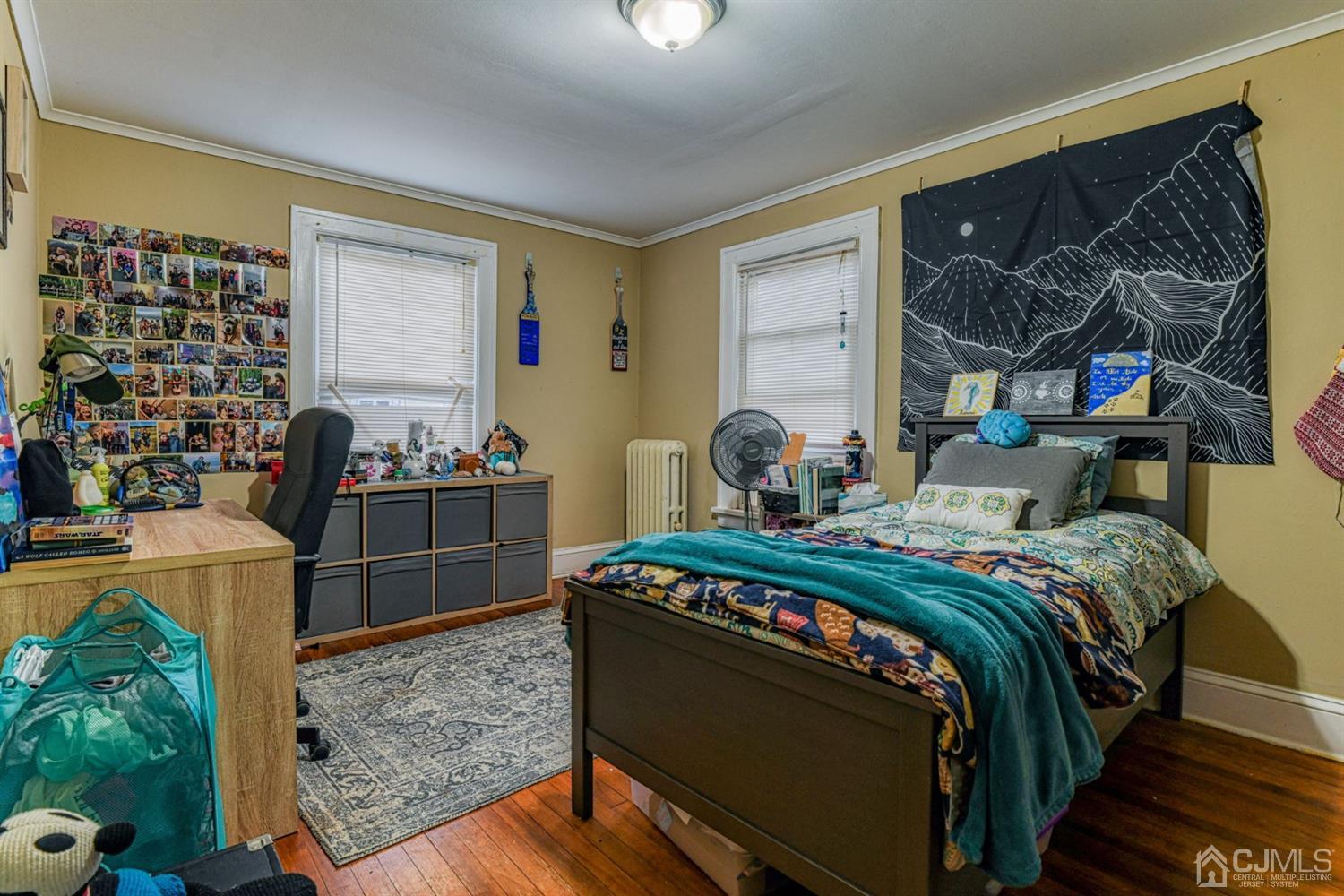 36 Baldwin Street New Brunswick, NJ 08901 - Photo 19 of 22 a bed sitting in a bedroom next to a window