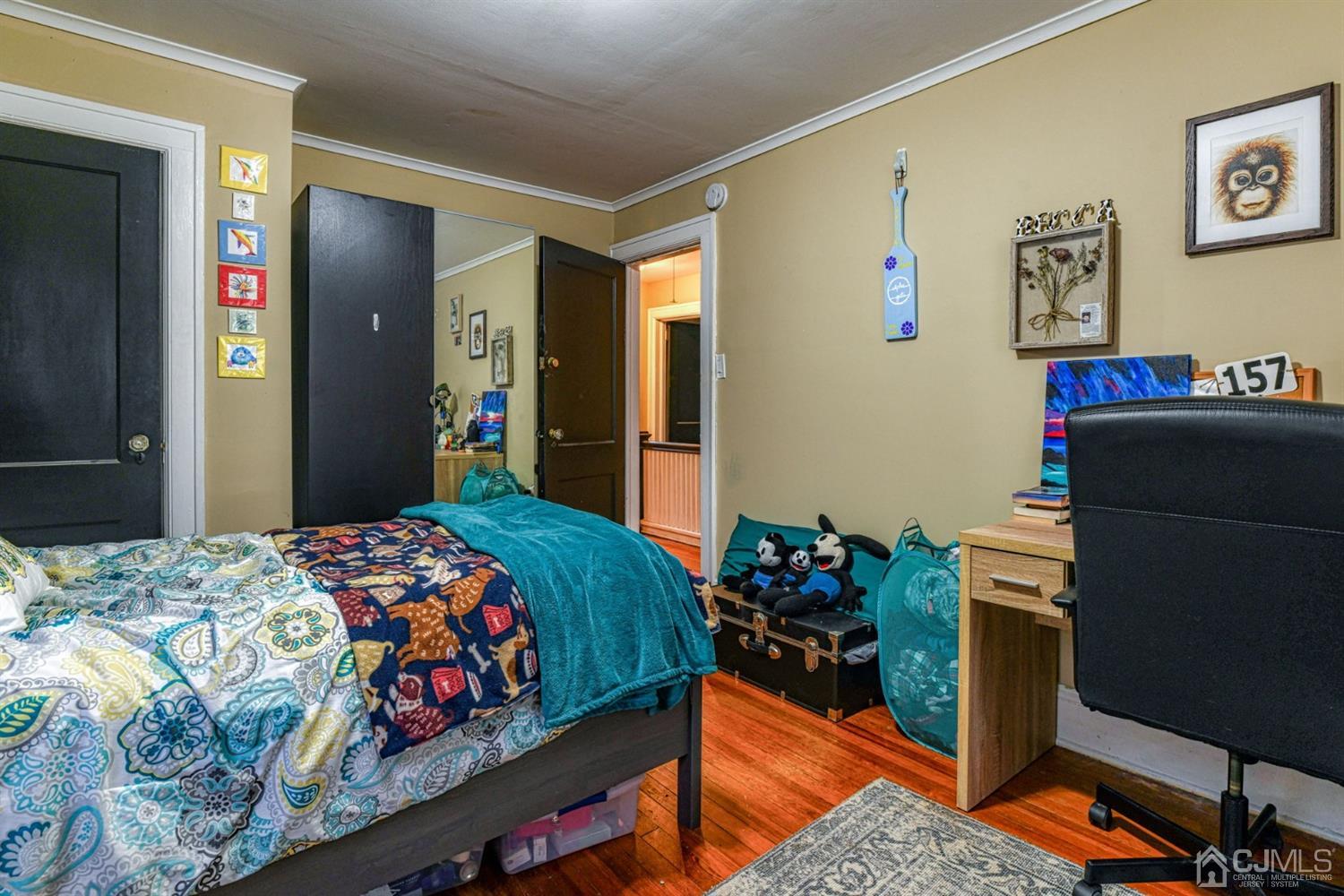 36 Baldwin Street New Brunswick, NJ 08901 - Photo 20 of 22 a bedroom with a bed and a dresser in it