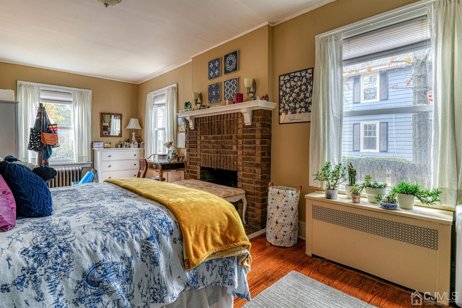 36 Baldwin Street New Brunswick, NJ 08901 - Photo 7 of 22 a bedroom with a bed and wooden floor