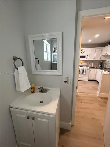 a bathroom with a sink a vanity and mirror