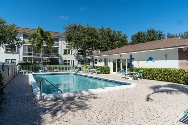a view of a house with pool yard and a patio