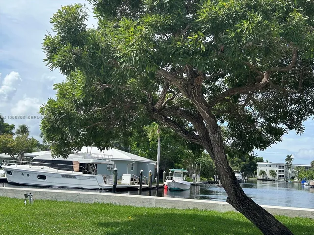 a view of a big yard with table and chairs under an umbrella