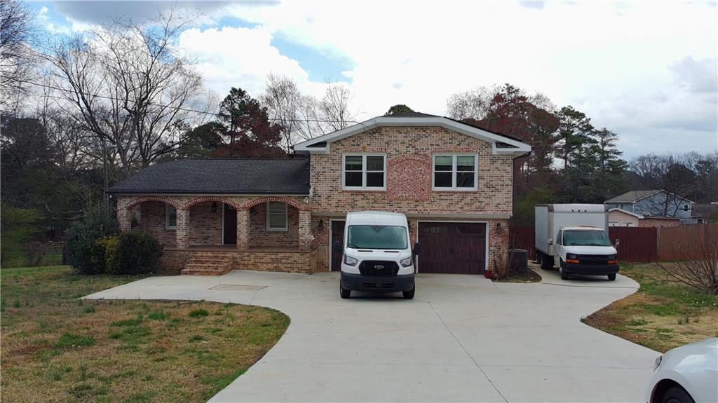 1292 Monfort Road Lawrenceville, GA 30046 - Photo 1 of 48 a front view of a house with a yard
