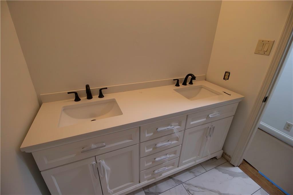 1292 Monfort Road Lawrenceville, GA 30046 - Photo 11 of 48 a bathroom with a sink and a mirror