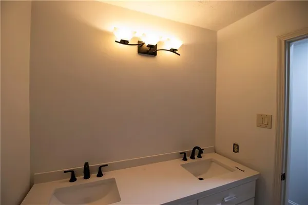 a bathroom with a sink and mirror