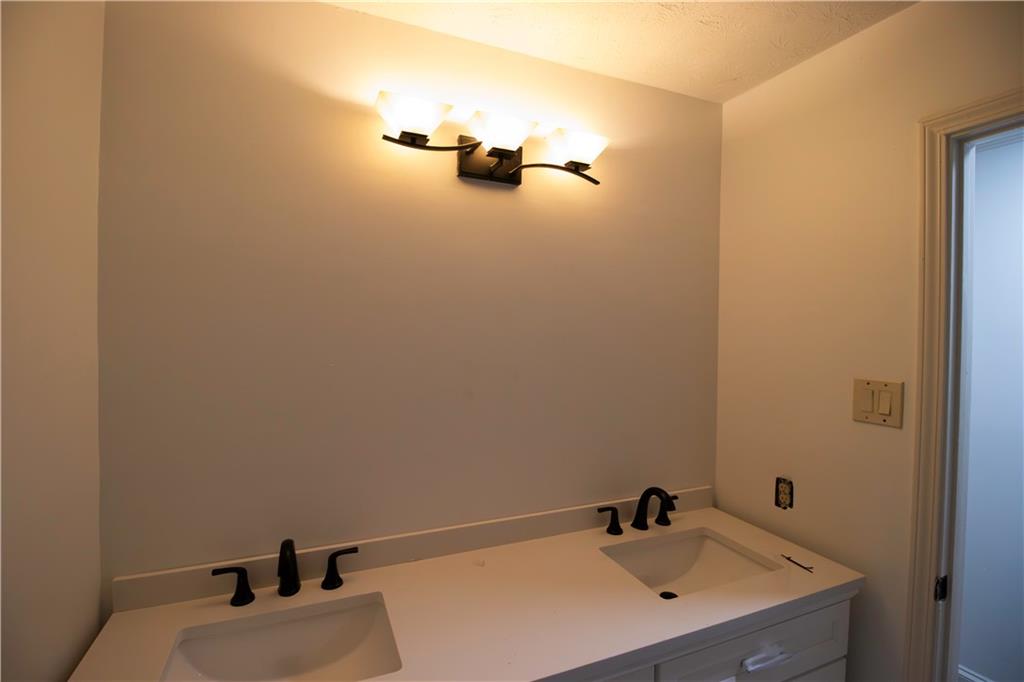 1292 Monfort Road Lawrenceville, GA 30046 - Photo 12 of 48 a bathroom with a sink and mirror