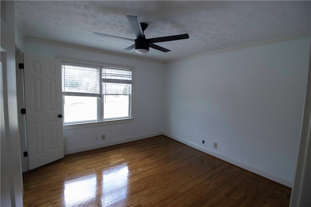 1292 Monfort Road Lawrenceville, GA 30046 - Photo 13 of 48 wooden floor in an empty room with a window