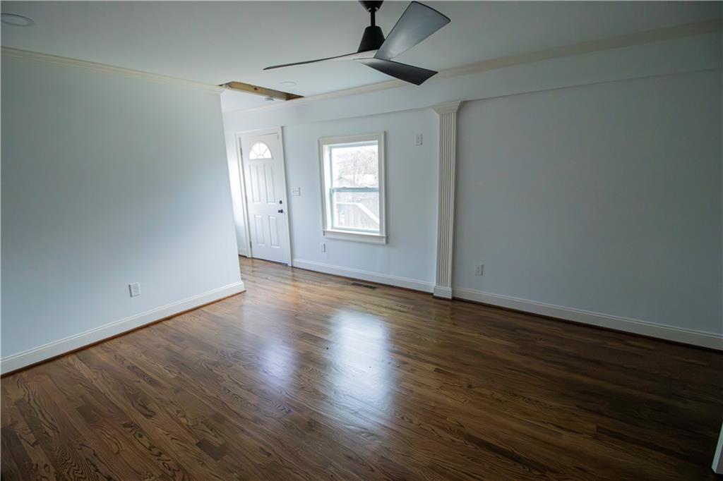 1292 Monfort Road Lawrenceville, GA 30046 - Photo 19 of 48 a view of empty room with wooden floor and fan