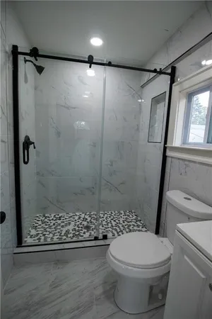 a bathroom with a sink toilet and shower