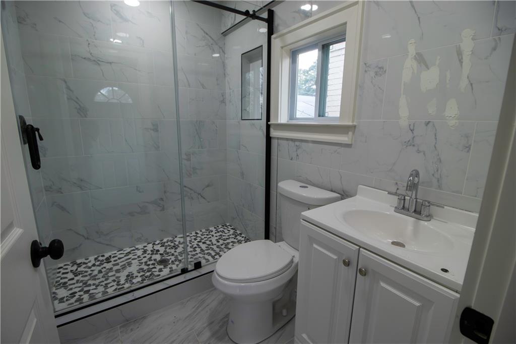 1292 Monfort Road Lawrenceville, GA 30046 - Photo 25 of 48 a bathroom with a sink toilet and shower