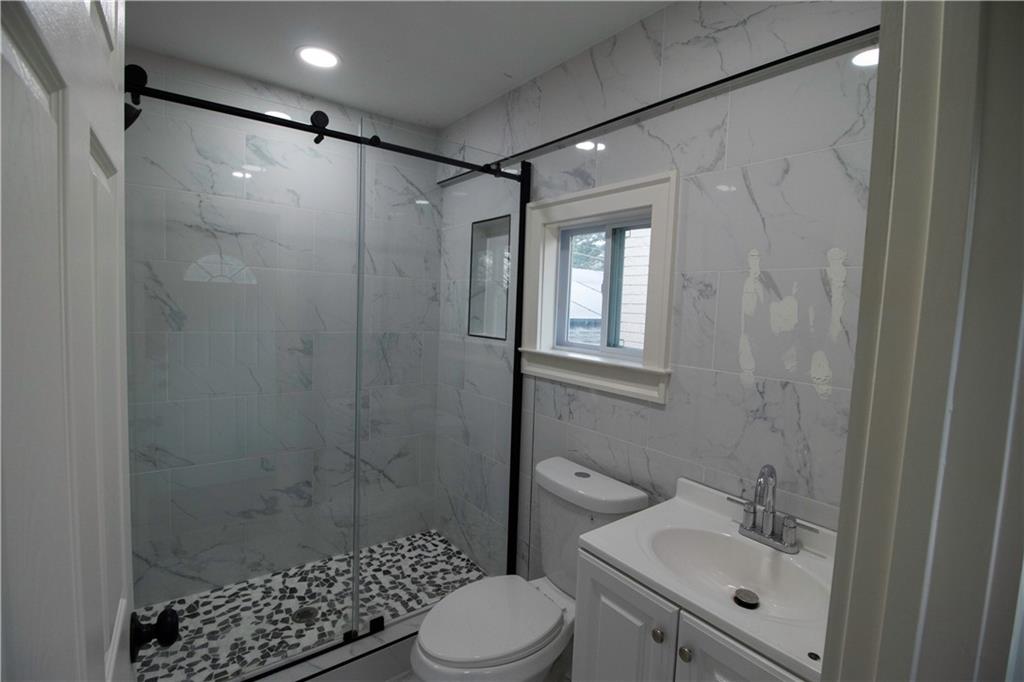 1292 Monfort Road Lawrenceville, GA 30046 - Photo 26 of 48 a bathroom with a shower toilet and sink