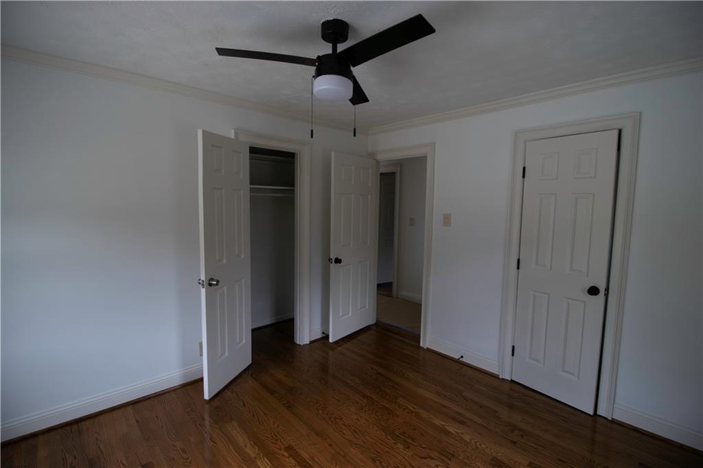 1292 Monfort Road Lawrenceville, GA 30046 - Photo 29 of 48 a view of a room with wooden floor and ceiling fan