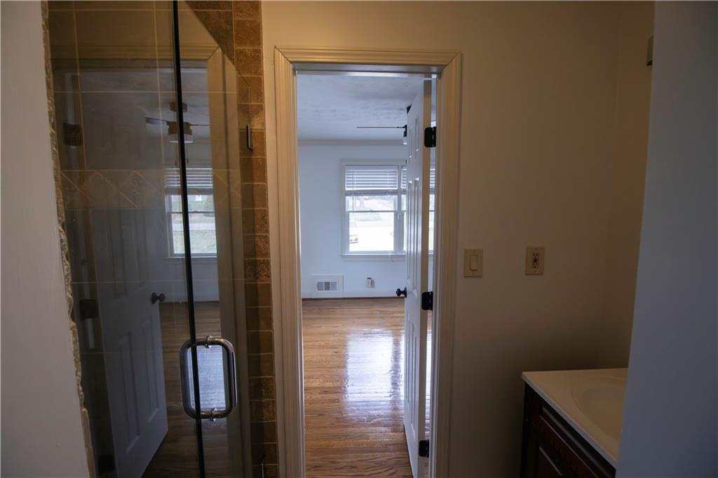 1292 Monfort Road Lawrenceville, GA 30046 - Photo 31 of 48 a bathroom with a glass shower door