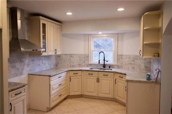 a kitchen with a sink stove and cabinets