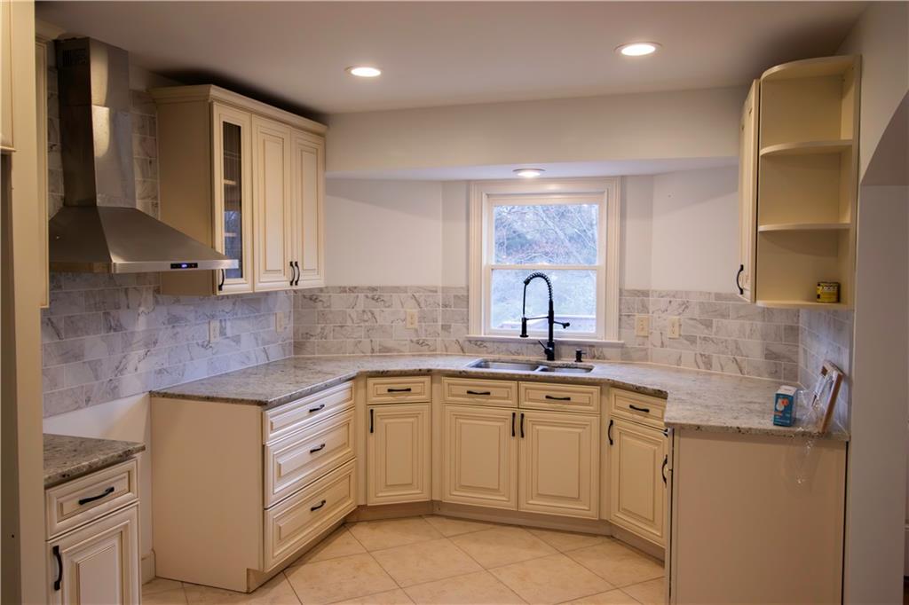 1292 Monfort Road Lawrenceville, GA 30046 - Photo 4 of 48 a kitchen with a sink stove and cabinets