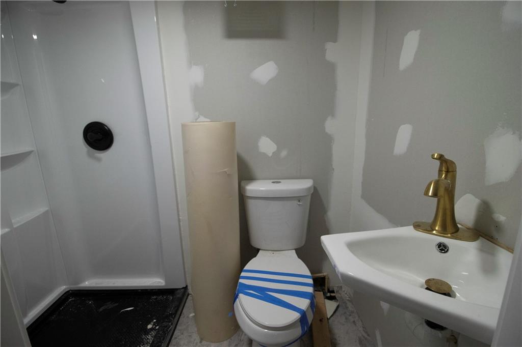 1292 Monfort Road Lawrenceville, GA 30046 - Photo 41 of 48 a bathroom with a sink and toilet