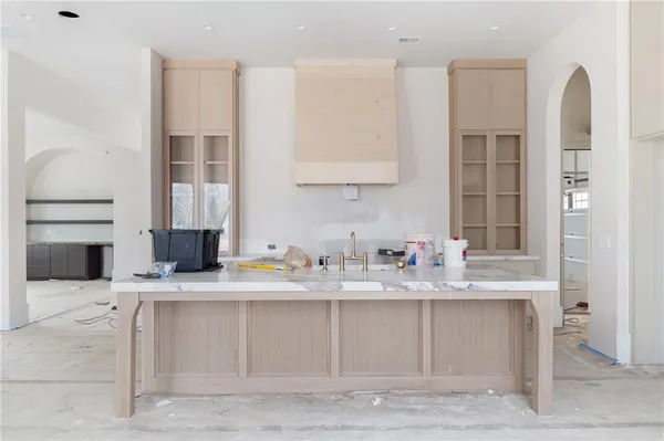 a kitchen with a sink stove and cabinets