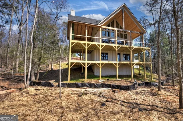 a backyard of a house with barbeque oven and wooden fence