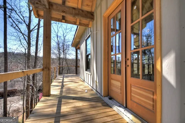 a view of a balcony with wooden floor and door