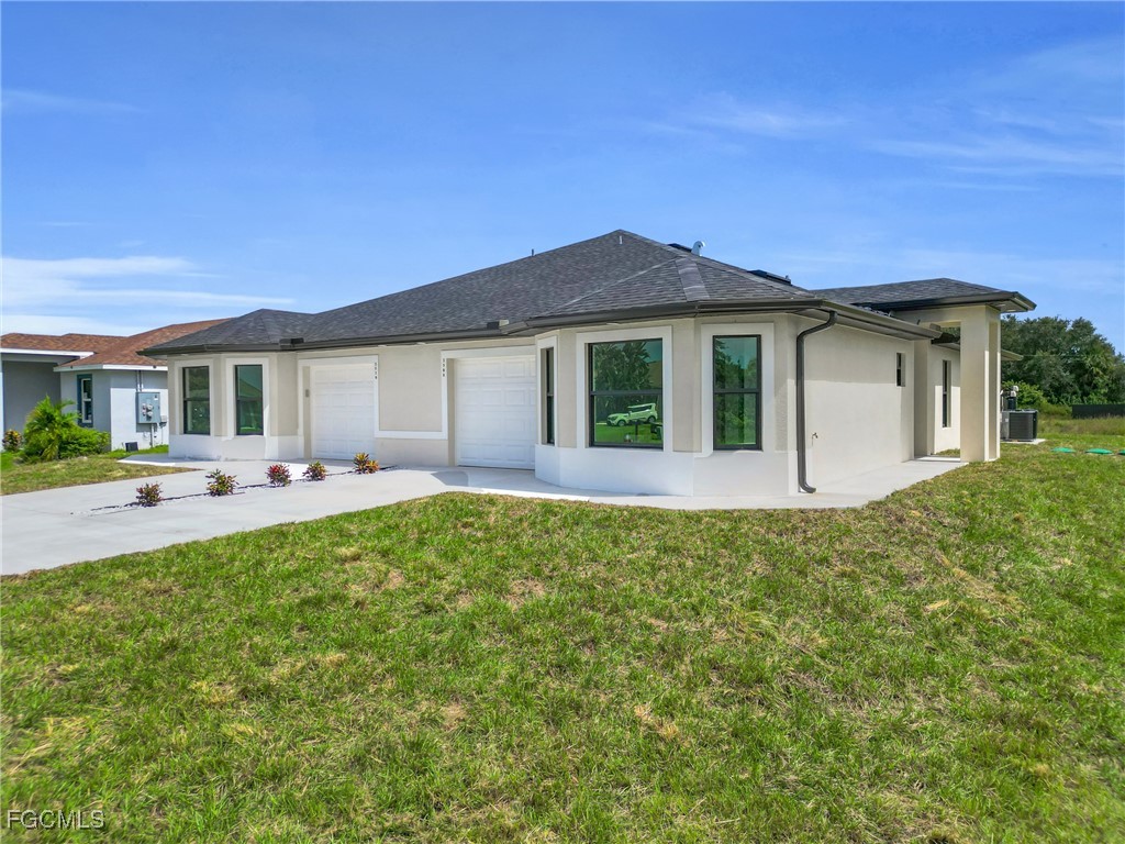 2508-2510 Park Road Lehigh Acres, FL 33971 - Photo 3 of 37 a front view of a house with yard patio and fire pit